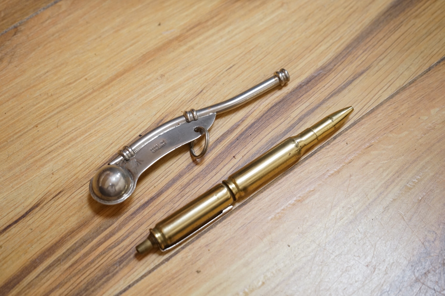 A collection of military related items, including an instrument panel from a WWII RAF Lancaster bomber aircraft, a Bosun’s whistle, a Heckler and Koch ‘bullet’ pen, a WWII tin hat (possibly police), a pith helmet, an Aus